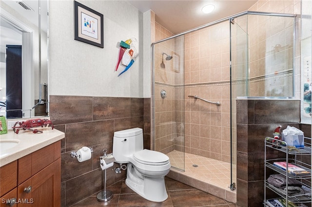 14270 Royal Harbour Ct Unit 323, Fort Myers, FL 33908 - full bathroom featuring vanity, tile walls, a shower stall, and tile patterned floors