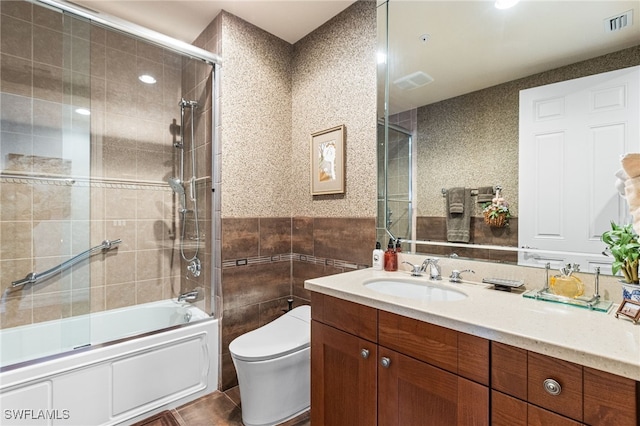 14270 Royal Harbour Ct Unit 323, Fort Myers, FL 33908 - bathroom featuring tile walls, vanity, enclosed tub / shower combo, and tile patterned flooring