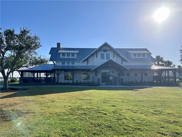 16325 Preservation Blvd, Punta Gorda, FL 33982 - view of front facade featuring metal roof, a front lawn, and a chimney