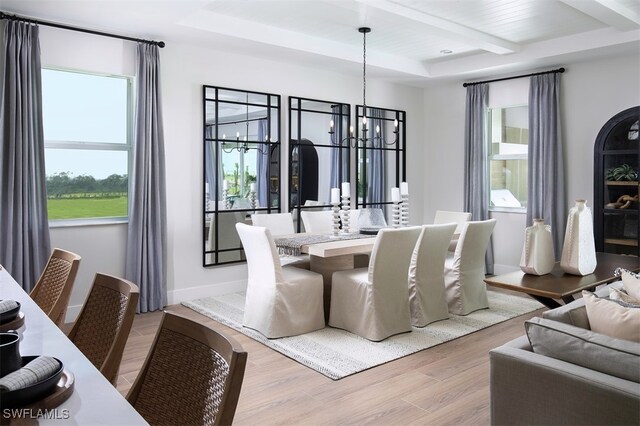 dining space with an inviting chandelier, beamed ceiling, light wood finished floors, and a healthy amount of sunlight