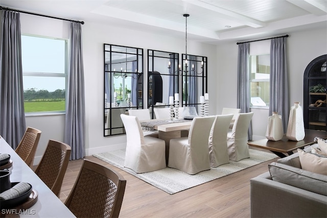 16325 Preservation Blvd, Punta Gorda, FL 33982 - dining room with a chandelier, light wood-style floors, beamed ceiling, and a raised ceiling