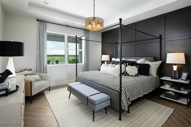 bedroom with baseboards, recessed lighting, and a raised ceiling