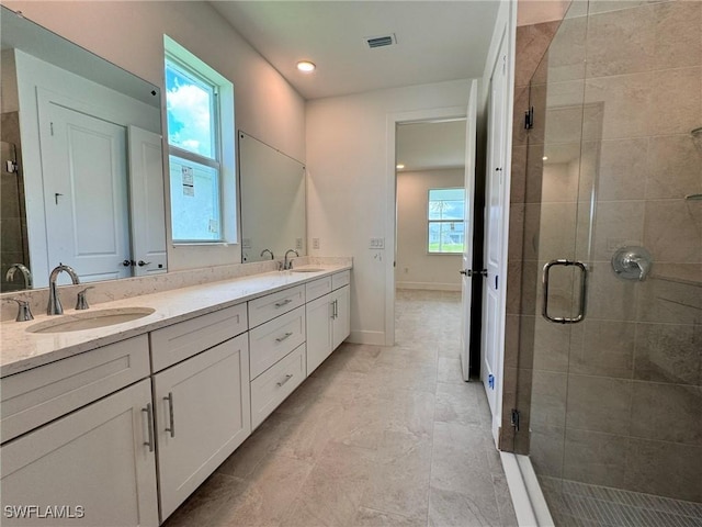 16325 Preservation Blvd, Punta Gorda, FL 33982 - bathroom featuring double vanity, a stall shower, recessed lighting, and baseboards