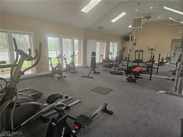 exercise room featuring high vaulted ceiling, visible vents, baseboards, and a ceiling fan