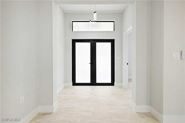 entryway with wood finished floors and baseboards