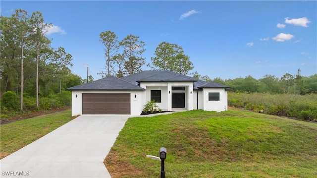 prairie-style house featuring stucco siding, an attached garage, a front yard, and concrete driveway
