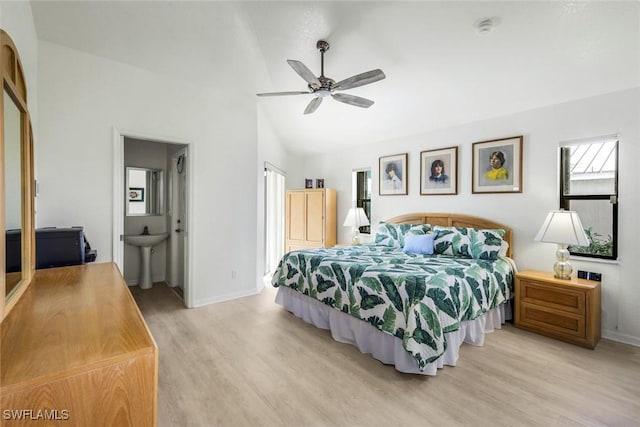 2556 SW 28th Pl, Cape Coral, FL 33914 - bedroom with a ceiling fan, baseboards, a sink, light wood-style flooring, and vaulted ceiling