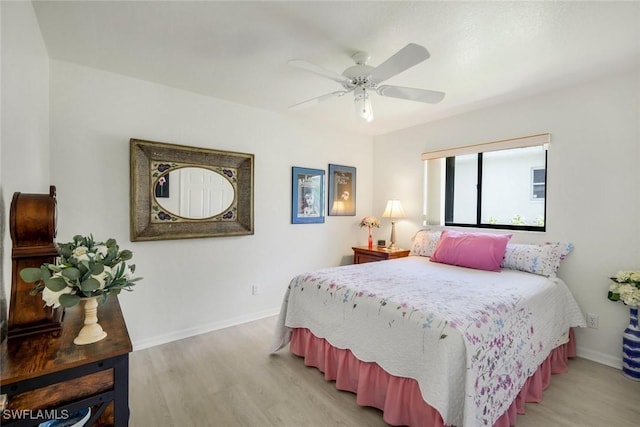 2556 SW 28th Pl, Cape Coral, FL 33914 - bedroom with baseboards, light wood-style flooring, and ceiling fan