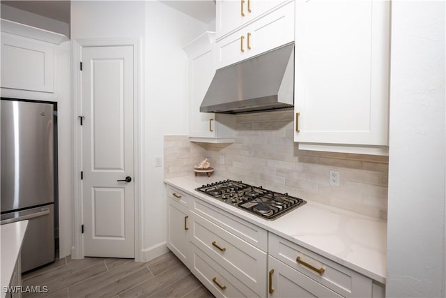 17554 Terracina Dr, Fort Myers, FL 33913 - kitchen featuring white cabinets, under cabinet range hood, and stainless steel appliances