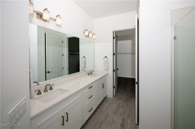 17554 Terracina Dr, Fort Myers, FL 33913 - bathroom featuring double vanity, a sink, a spacious closet, and wood tiled floor