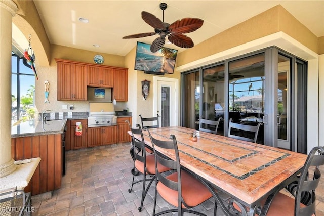 4536 SW 12th Pl, Cape Coral, FL 33914 - dining room featuring a wealth of natural light, a ceiling fan, and stone finish flooring