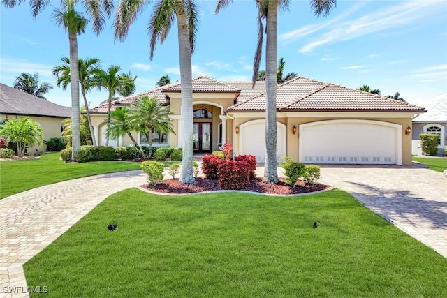 4536 SW 12th Pl, Cape Coral, FL 33914 - mediterranean / spanish-style home featuring stucco siding, decorative driveway, a front lawn, a tile roof, and a garage