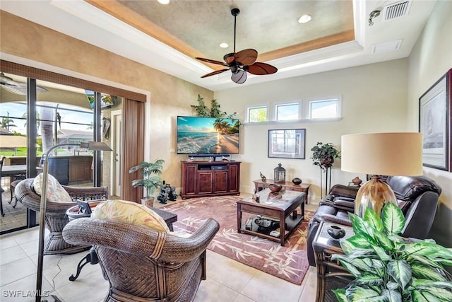 4536 SW 12th Pl, Cape Coral, FL 33914 - living area with light tile patterned floors, a raised ceiling, visible vents, and a ceiling fan