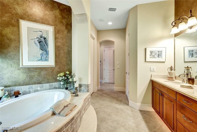 4536 SW 12th Pl, Cape Coral, FL 33914 - full bathroom with visible vents, a bath, baseboards, vanity, and tile patterned floors