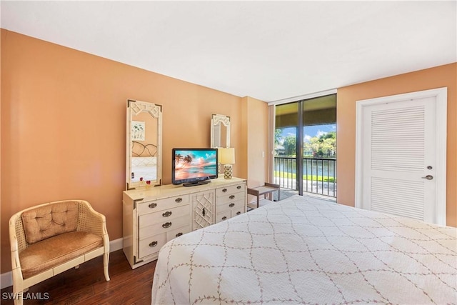 bedroom featuring access to exterior, baseboards, and dark wood finished floors