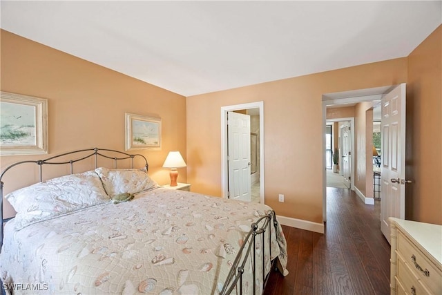 bedroom with dark wood-type flooring and baseboards