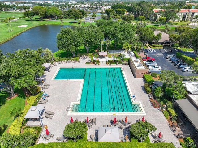 view of swimming pool featuring a water view