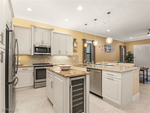 11552 Riverstone Ln, Fort Myers, FL 33913 - kitchen featuring appliances with stainless steel finishes, wine cooler, a peninsula, a center island, and a sink
