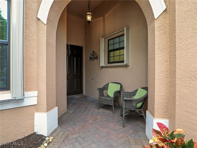 11552 Riverstone Ln, Fort Myers, FL 33913 - doorway to property featuring stucco siding and a patio area