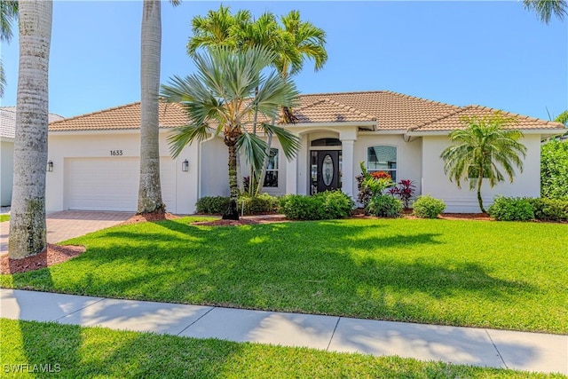 1633 Barbarosa Ct, Marco Island, FL 34145 - view of front facade featuring stucco siding, driveway, an attached garage, a front yard, and a tiled roof