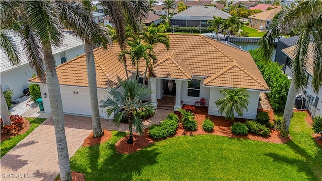 1633 Barbarosa Ct, Marco Island, FL 34145 - mediterranean / spanish-style house featuring a tiled roof, a residential view, a garage, and decorative driveway