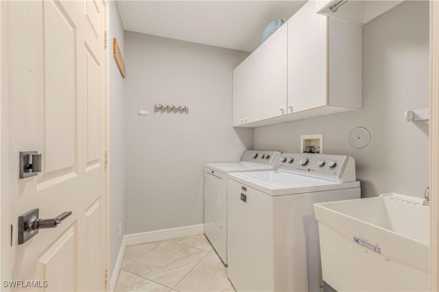 1633 Barbarosa Ct, Marco Island, FL 34145 - laundry room featuring baseboards, a sink, washing machine and clothes dryer, and cabinet space