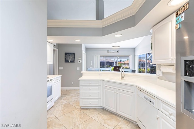 1633 Barbarosa Ct, Marco Island, FL 34145 - kitchen with crown molding, white appliances, white cabinetry, a sink, and light countertops