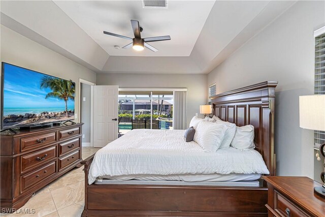 1633 Barbarosa Ct, Marco Island, FL 34145 - bedroom featuring a tray ceiling, access to outside, a ceiling fan, and visible vents