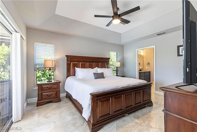 1633 Barbarosa Ct, Marco Island, FL 34145 - bedroom with a tray ceiling, baseboards, ensuite bathroom, and visible vents