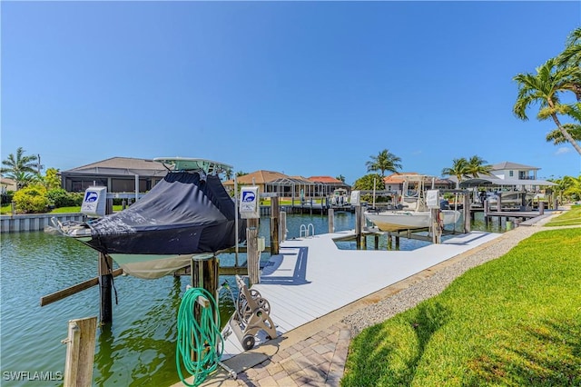 1633 Barbarosa Ct, Marco Island, FL 34145 - dock area with boat lift, a lawn, and a water view