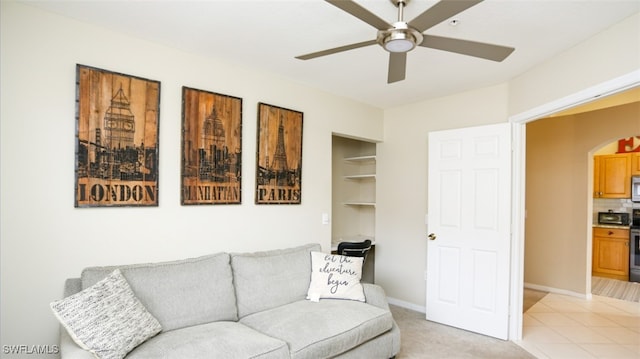 6645 Huntington Lakes Cir Unit 201, Naples, FL 34119 - living area with light colored carpet, arched walkways, a ceiling fan, and baseboards