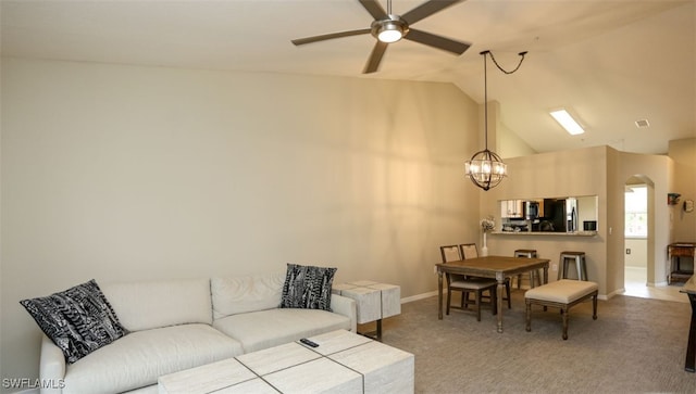 6645 Huntington Lakes Cir Unit 201, Naples, FL 34119 - living room with ceiling fan with notable chandelier, arched walkways, carpet, baseboards, and lofted ceiling