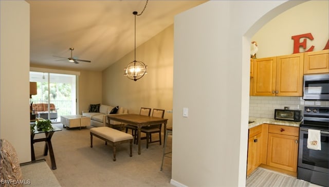 6645 Huntington Lakes Cir Unit 201, Naples, FL 34119 - kitchen featuring light carpet, arched walkways, stainless steel microwave, and electric range