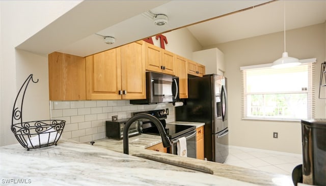6645 Huntington Lakes Cir Unit 201, Naples, FL 34119 - kitchen with light stone counters, tasteful backsplash, light brown cabinets, and stainless steel appliances