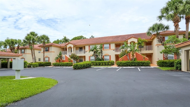 6645 Huntington Lakes Cir Unit 201, Naples, FL 34119 - view of building exterior featuring uncovered parking and a residential view