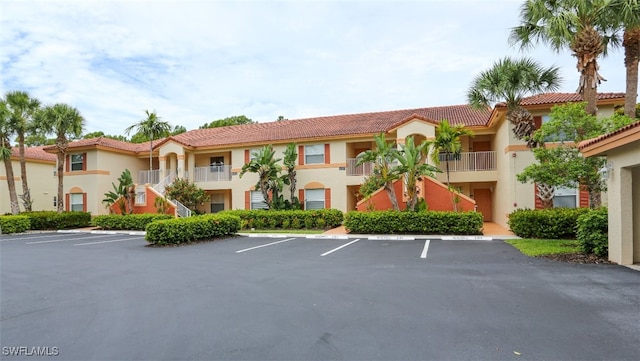 6645 Huntington Lakes Cir Unit 201, Naples, FL 34119 - view of building exterior with uncovered parking and stairs