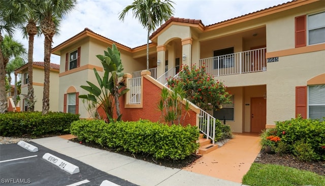 6645 Huntington Lakes Cir Unit 201, Naples, FL 34119 - view of building exterior with uncovered parking and stairs