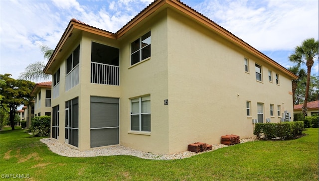 6645 Huntington Lakes Cir Unit 201, Naples, FL 34119 - exterior space with a yard, a tile roof, and stucco siding