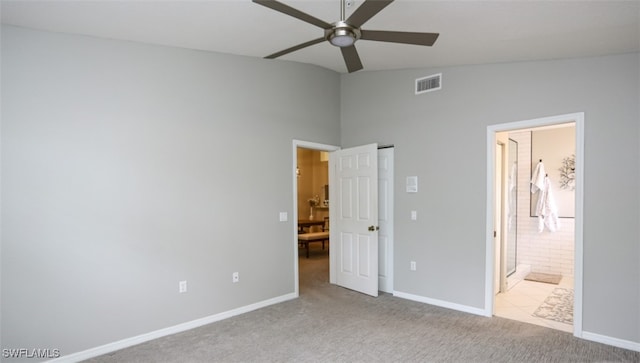 6645 Huntington Lakes Cir Unit 201, Naples, FL 34119 - unfurnished bedroom featuring ensuite bathroom, carpet floors, baseboards, lofted ceiling, and visible vents