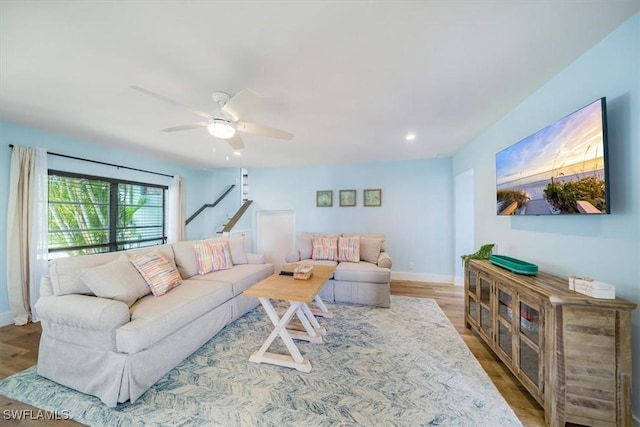 living room featuring wood finished floors, ceiling fan, baseboards, and recessed lighting
