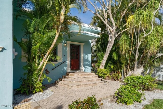 entrance to property featuring stucco siding