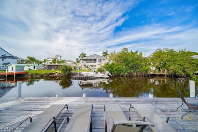 dock area with a water view and a residential view