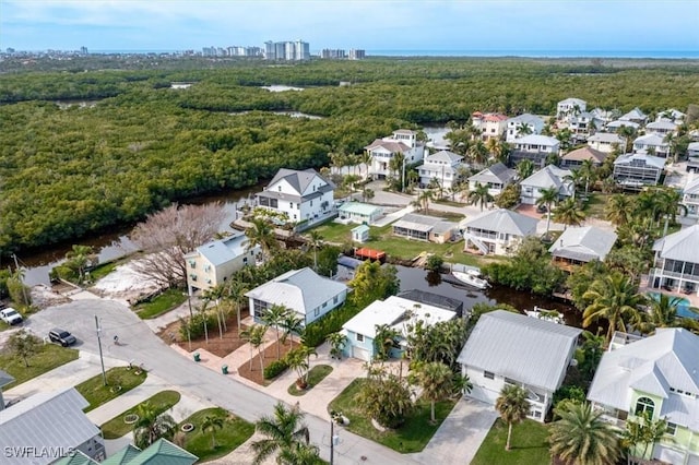bird's eye view with a wooded view and a residential view