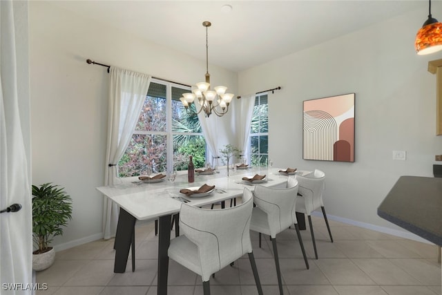 tiled dining room with baseboards and a notable chandelier