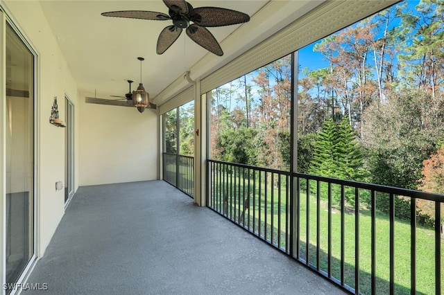 unfurnished sunroom featuring ceiling fan