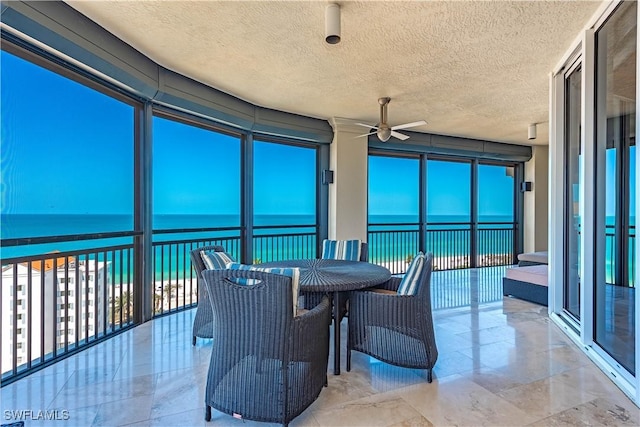 81 Seagate Dr Unit 1101, Naples, FL 34103 - sunroom with a water view, a textured ceiling, and marble finish flooring