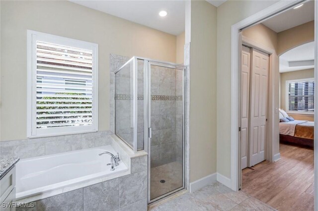 9102 Limestone Ln, Naples, FL 34120 - bathroom with a bath, a stall shower, and baseboards