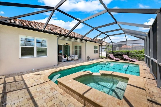 9102 Limestone Ln, Naples, FL 34120 - view of pool with an outdoor hangout area, a pool with connected hot tub, a ceiling fan, glass enclosure, and a patio area