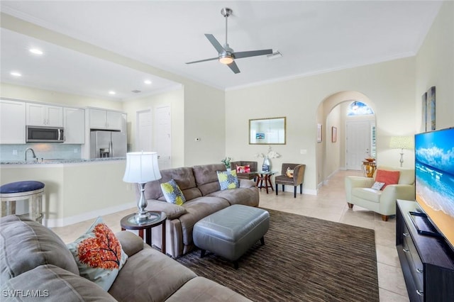 9102 Limestone Ln, Naples, FL 34120 - living room with arched walkways, ceiling fan, light tile patterned floors, and recessed lighting