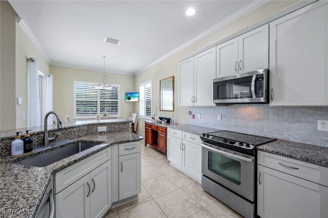 9102 Limestone Ln, Naples, FL 34120 - kitchen featuring an inviting chandelier, ornamental molding, backsplash, stainless steel appliances, and a sink